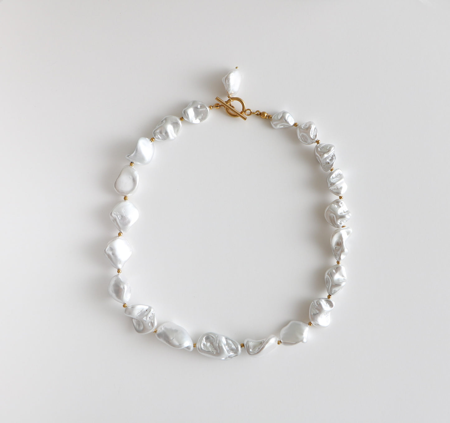 Chunky pearl necklace with thick pearls and gold beads interspersed, named the Birdie Pearl Necklace after the store owner's dog.