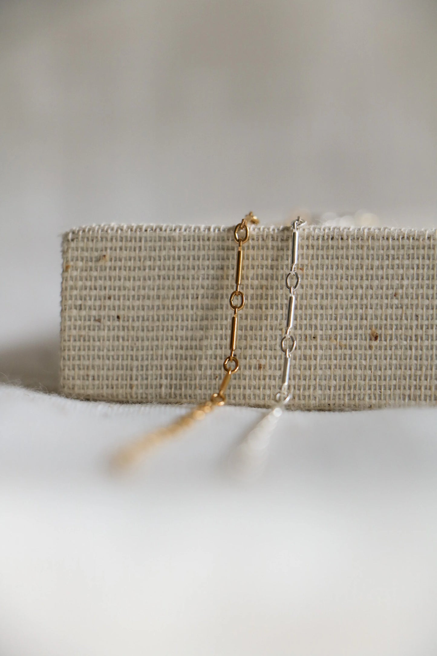 Gold-filled and sterling silver permanent jewelry, alternating circular and elongated sections with the name Bar Link, available at Charm City Links.