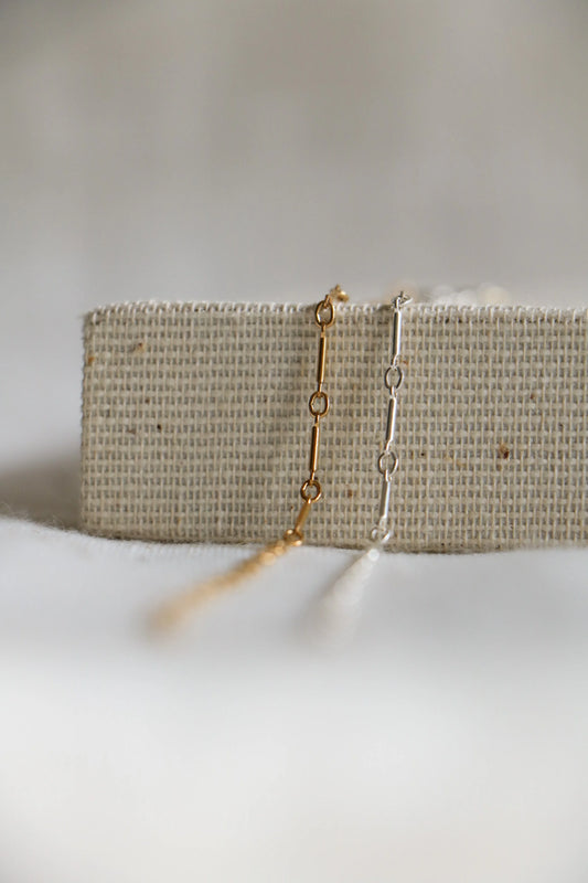 Gold-filled and sterling silver permanent jewelry, alternating circular and elongated sections with the name Bar Link, available at Charm City Links.