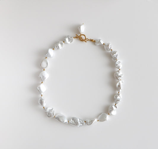 Chunky pearl necklace with thick pearls and gold beads interspersed, named the Birdie Pearl Necklace after the store owner's dog. 