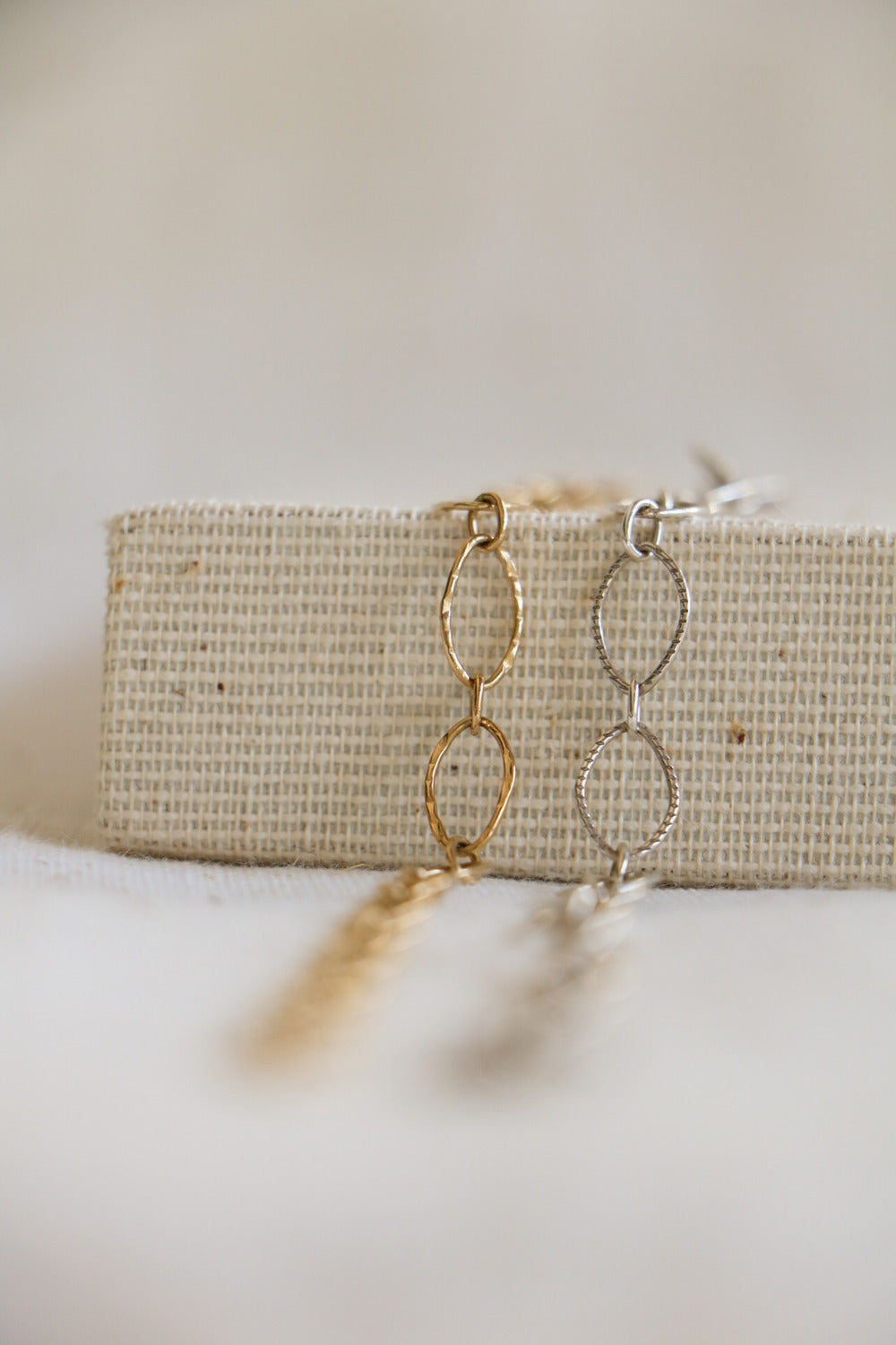 Gold-filled and sterling silver hammered jewelry chains with large oval links, used for permanent bracelets, anklets, or necklaces.