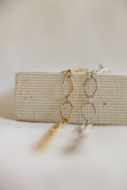 Gold-filled and sterling silver hammered jewelry chains with large oval links, used for permanent bracelets, anklets, or necklaces.